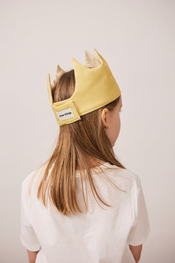 Boy with yellow queen's crown play hat