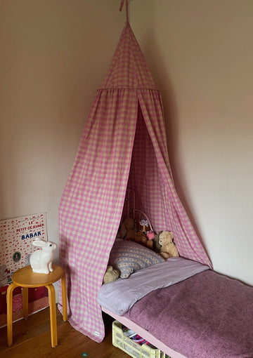 Pink Bed Canopy with gingham fabric over a bed