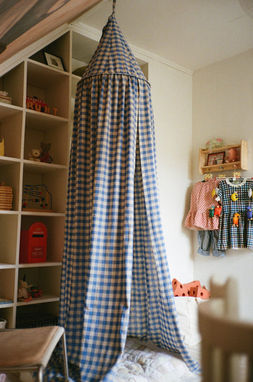 Blue Bed Canopy with gingham fabric in a children's room