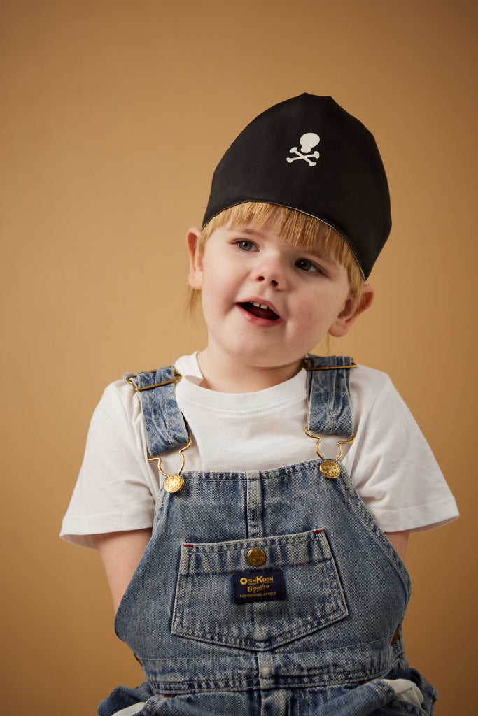Girl with black cotton pirate's play hat