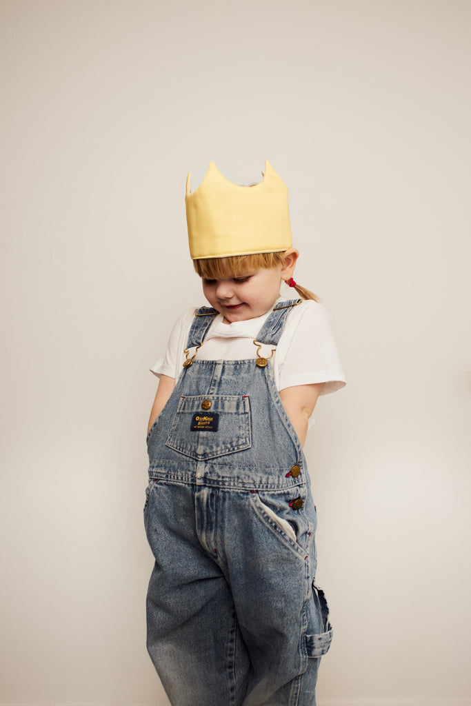 Girl with yellow queen's crown play hat