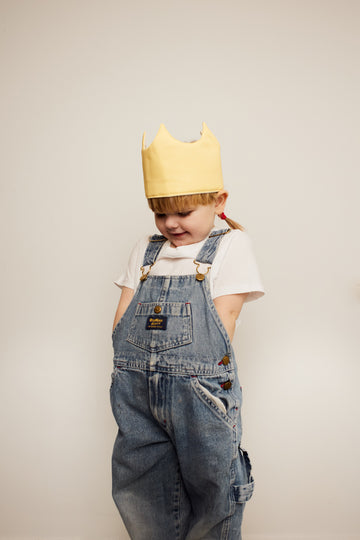 Girl with yellow queen's crown play hat