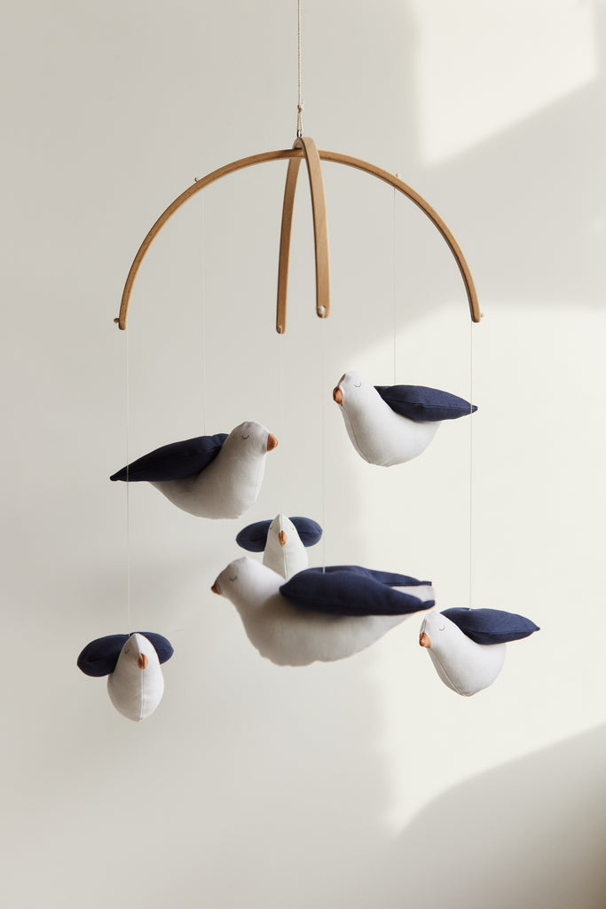 Baby mobile with cotton swallows and wooden hanger