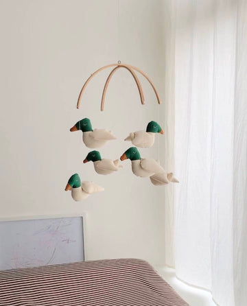 Baby mobile with cotton ducks and wooden hanger